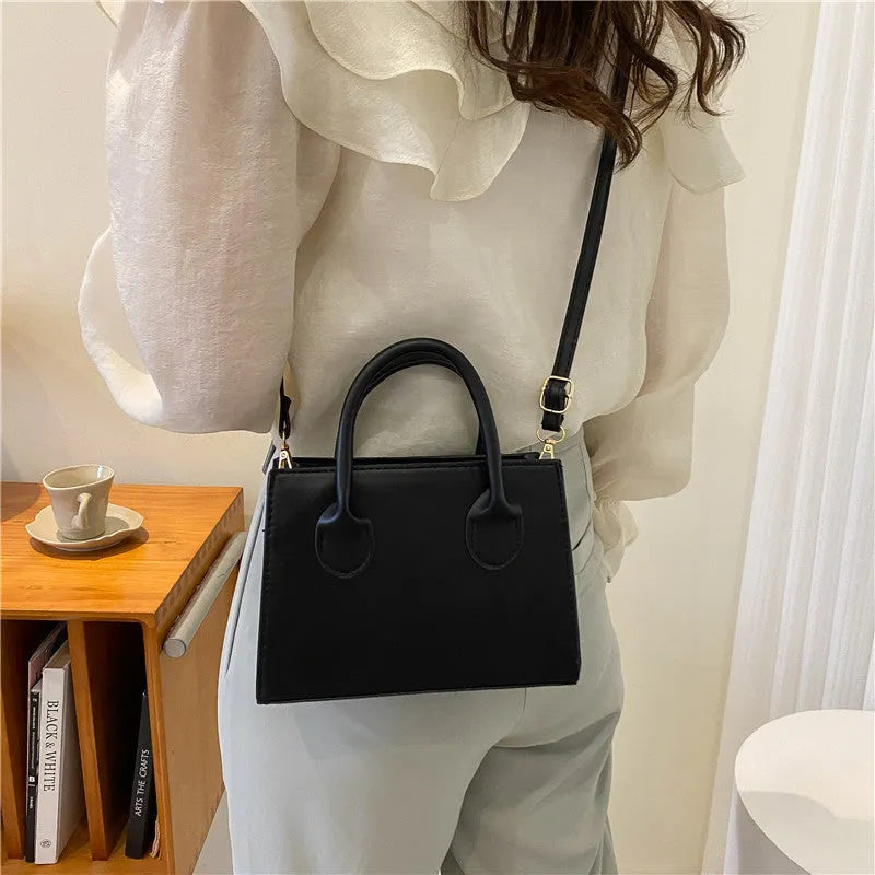 Small square shoulder bag in PU leather with single strap and document pocket, shown in available colours