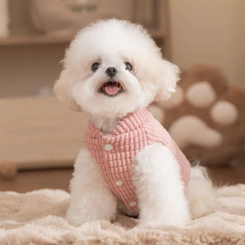 Pink ribbed corduroy dog vest with metal leash ring and bear emblem tag, sizes XS to XXL.