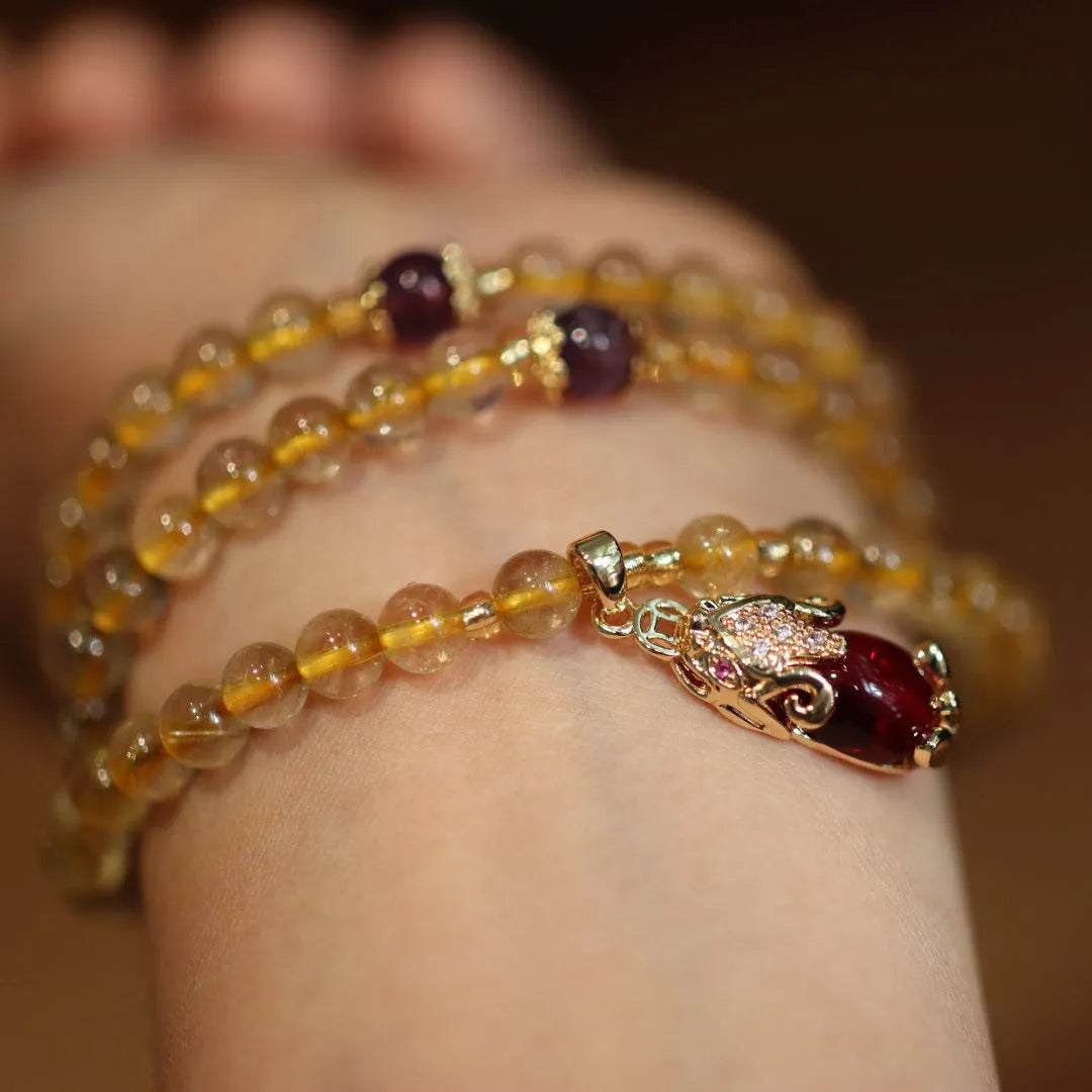 Natural Brazilian rutilated quartz bracelet with Chinese style three gold rings and hanging chopsticks design
