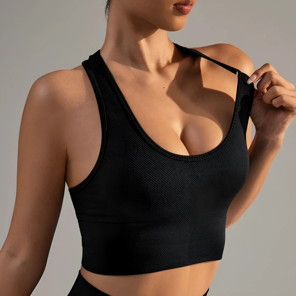 Black cross-back sports bra with moulded cups and fixed double straps on a mannequin