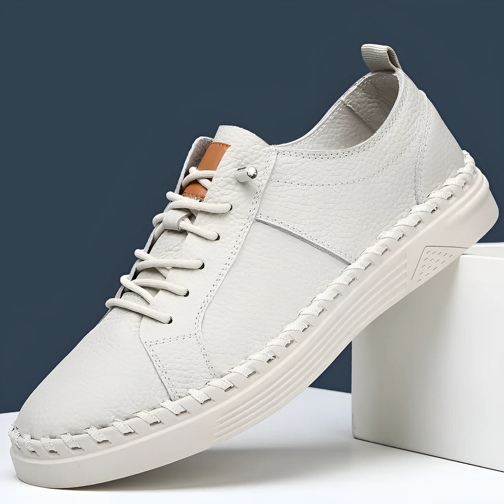 Beige and black men's round-toe cowhide sneakers with mesh lining and stitching detail.