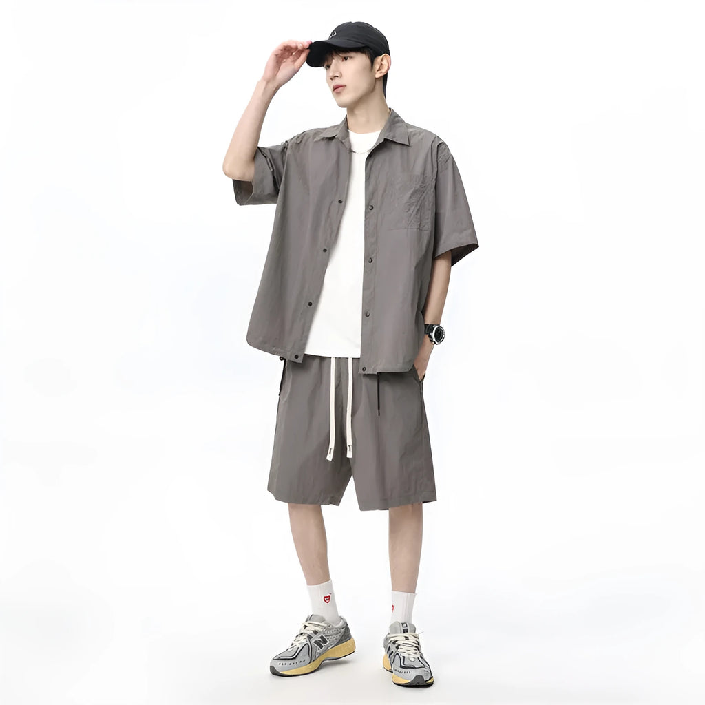 Man wearing a loose dark grey hemp-blend shirt and matching shorts casual two-piece set.