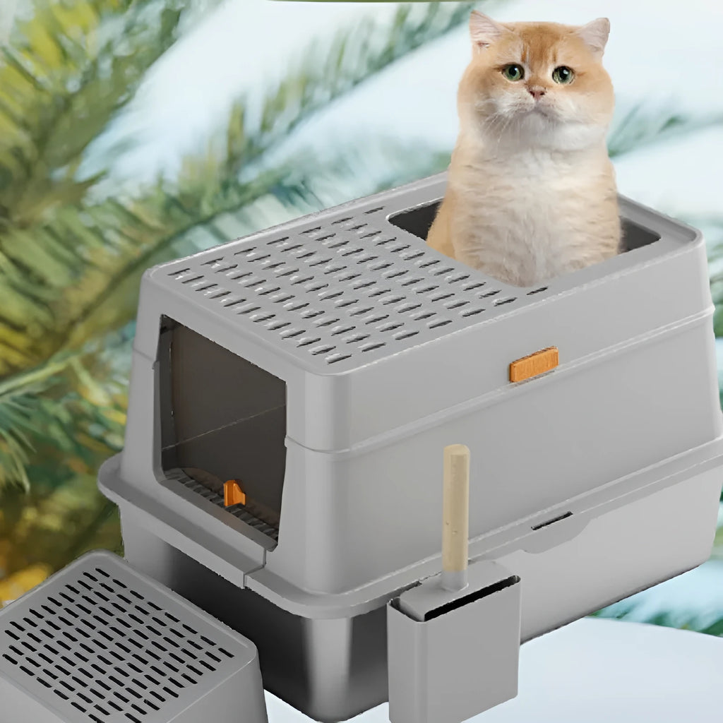 Grey fully enclosed hooded cat litter box with a foot pedal next to the front entrance door.