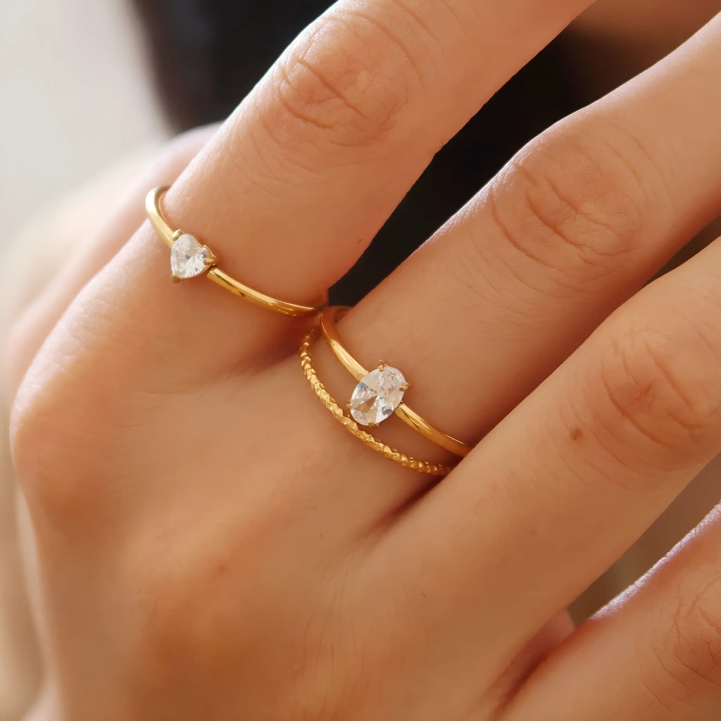 Golden heart-shaped stainless steel ring with electroplated finish available in two colour variations