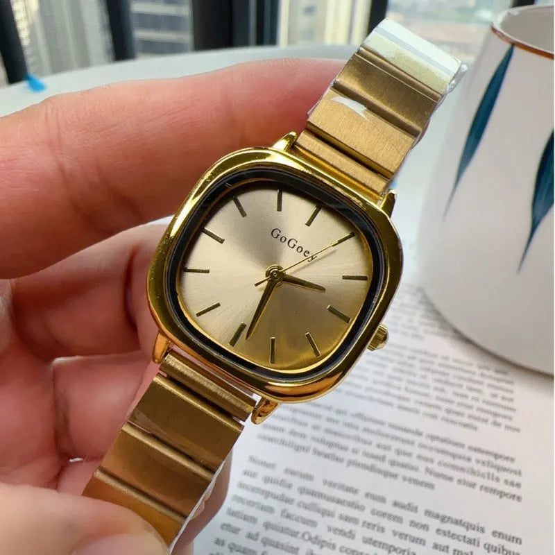 Women's quartz watch with metal case, steel strap and folding buckle, shown in gold or silver with green, white or gold surface