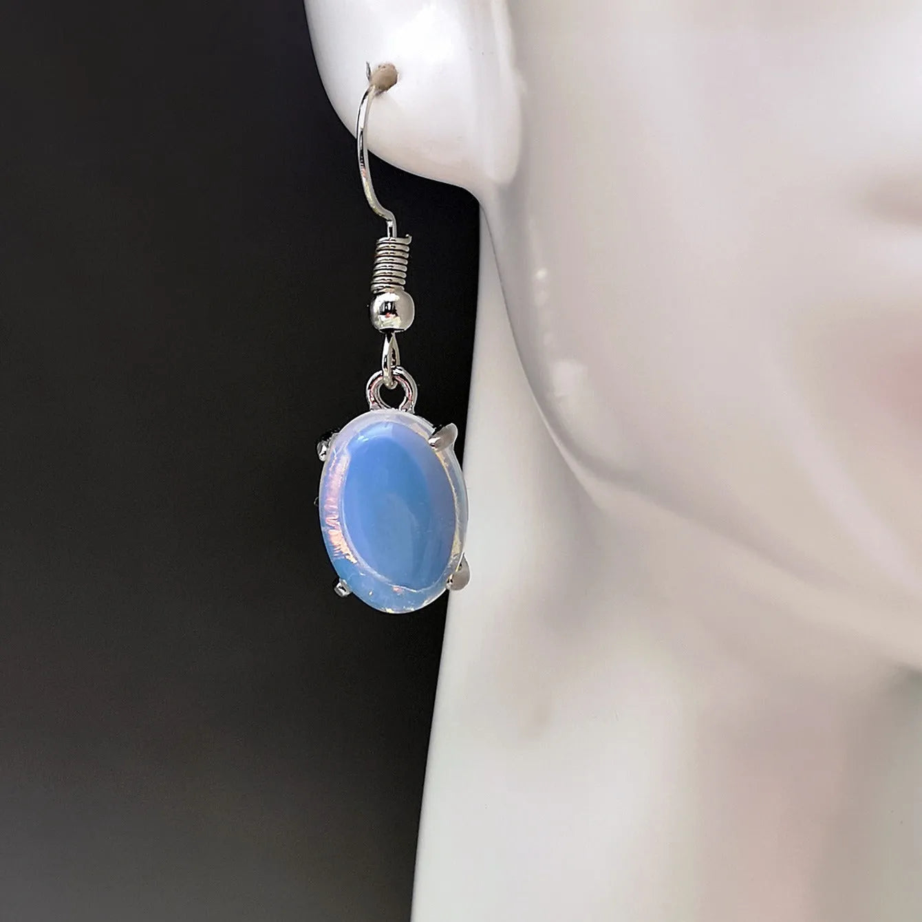 Moonlight white opal earrings with retro cross design and ellipse drop shape