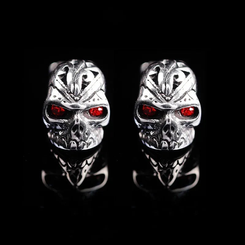 Pair of retro-style skull stud earrings with red gemstone eyes on alloy metal