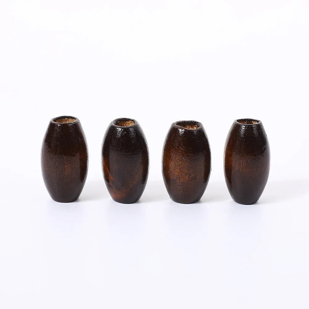 Dark coffee coloured oval wooden beads with M-shaped raised surface design