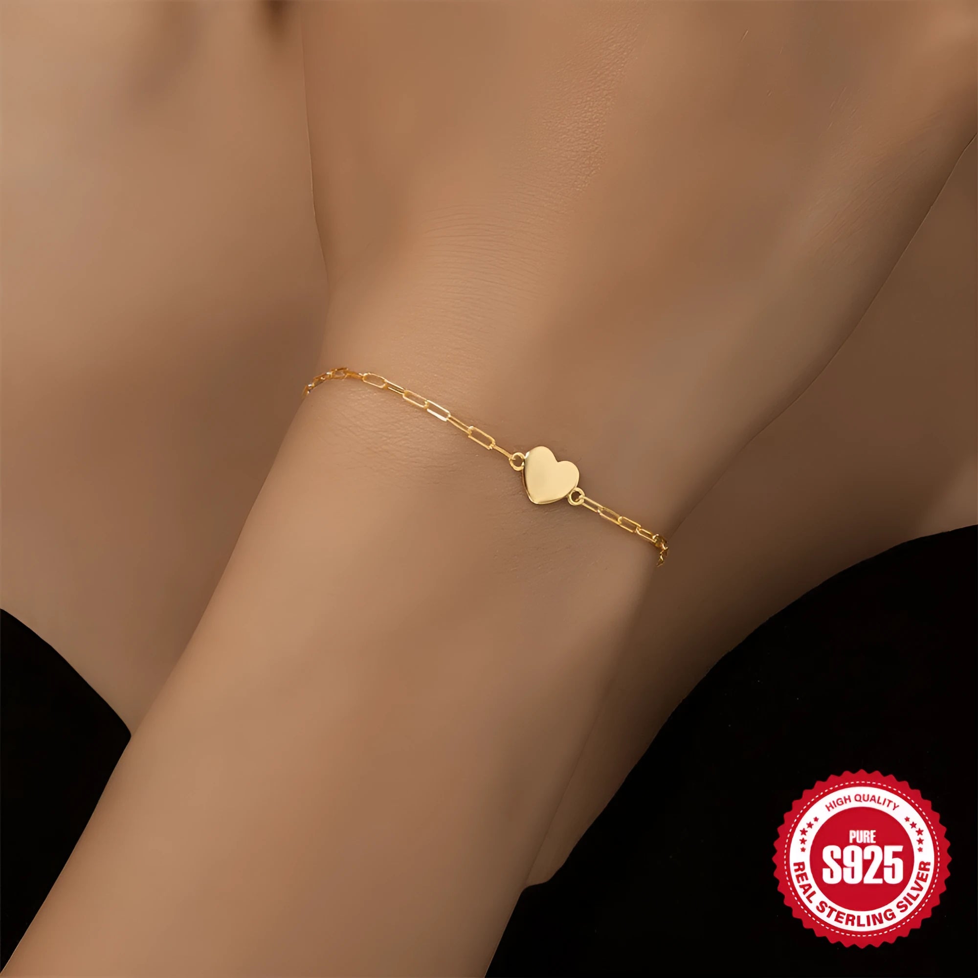 Gold plated sterling silver bracelet with geometric heart charm and clip chain clasp