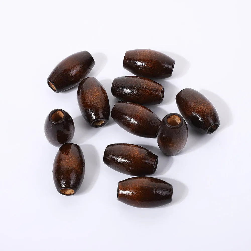 Dark coffee coloured oval wooden beads with M-shaped raised surface design