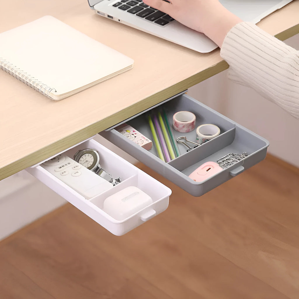 White adhesive under-table storage drawer with grid pattern mounted beneath a wooden desk.