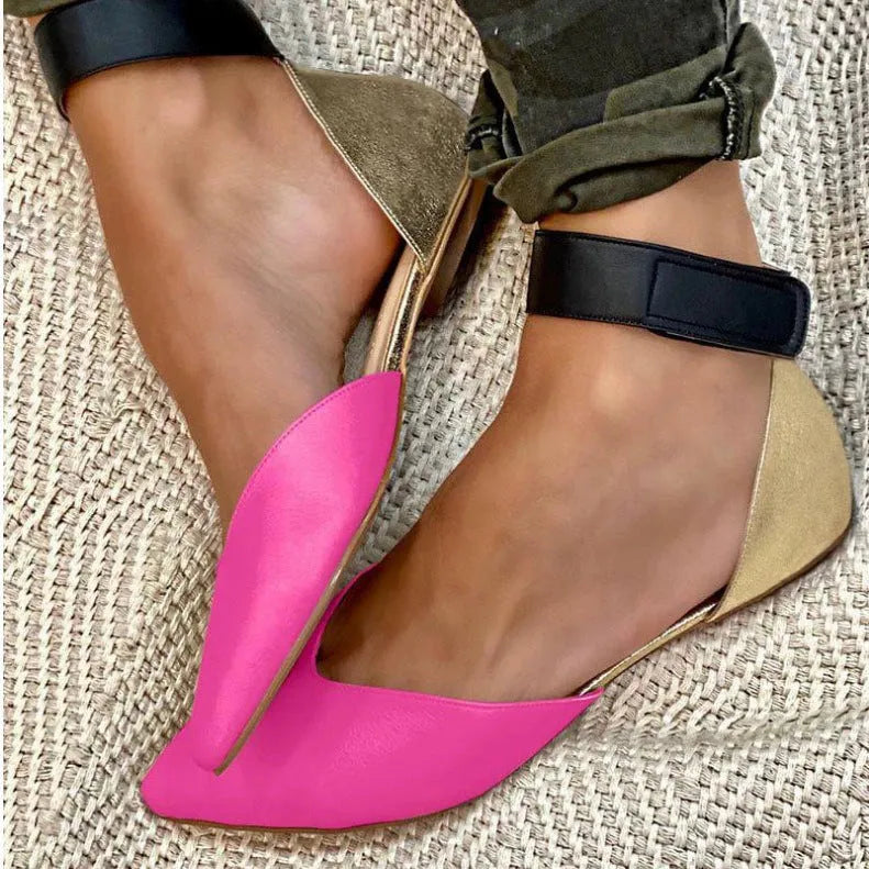 Women's beige velcro strap hollowed sandals with a flat heel on a plain background.