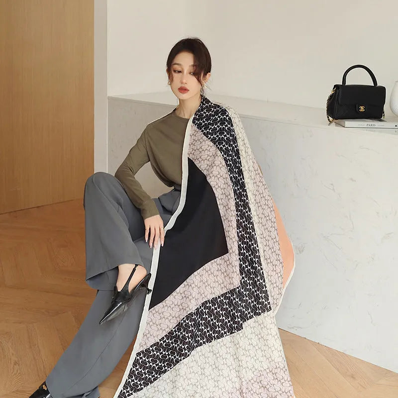 A woman wearing a printed polyester shawl, showcasing one of three available elegant styles, with dimensions of 180cm by 90cm.