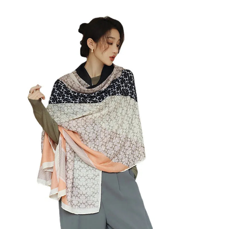 A woman wearing a printed polyester shawl, showcasing one of three available elegant styles, with dimensions of 180cm by 90cm.