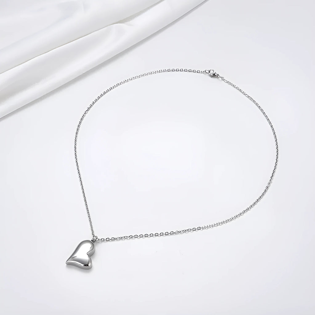 Silver curved peach heart stainless steel pendant necklace on a chain with extension