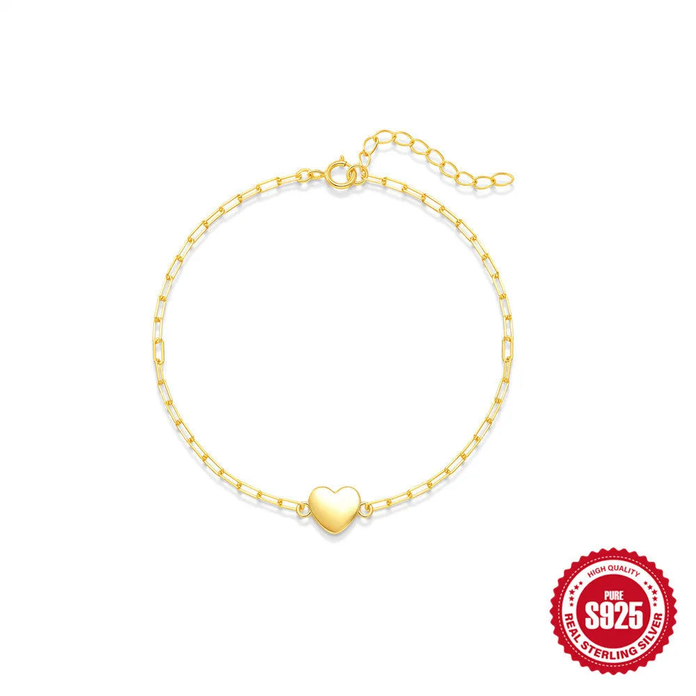 Gold plated sterling silver bracelet with geometric heart charm and clip chain clasp