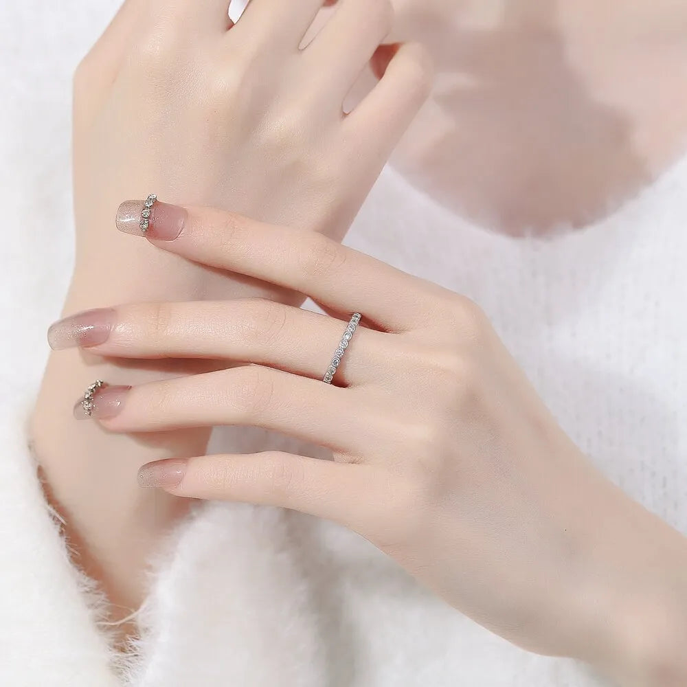Women's geometric open ring with a diamond tail detail in a white gold or yellow gold colour finish.