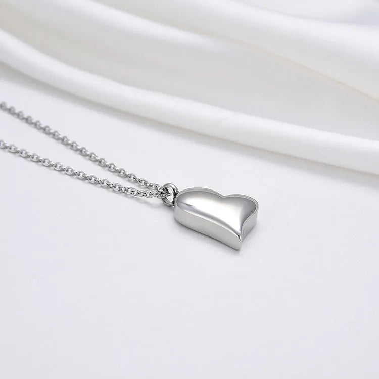 Silver curved peach heart stainless steel pendant necklace on a chain with extension
