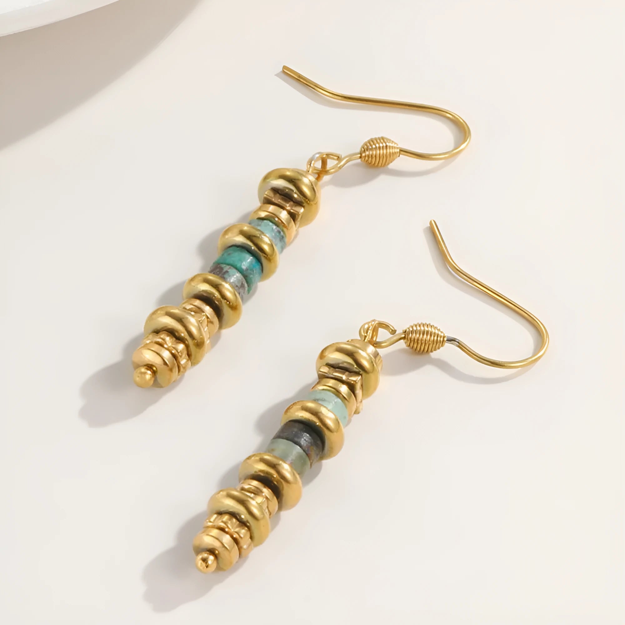 Geometric shaped titanium steel dangle earrings with a retro design on a white background.