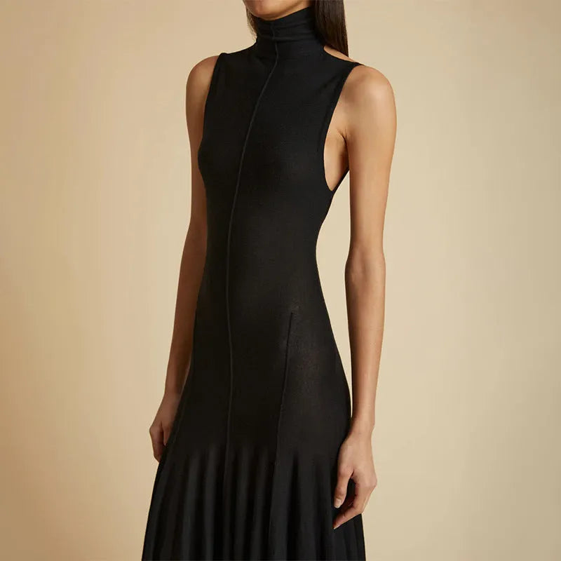 Grey slim-fit cotton dress with half turtleneck and backless design on a mannequin.