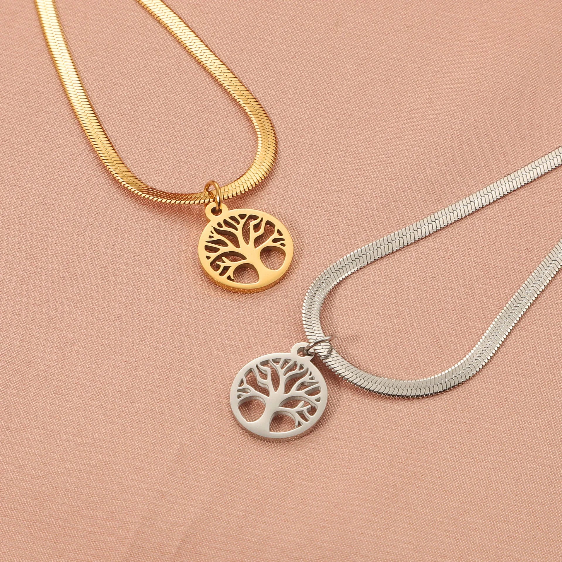 Stainless steel necklace with tree pendant on an adjustable snake bone chain in gold colour.