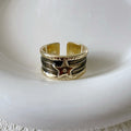 Adjustable geometric ring in distressed electroplated copper on a hand, showing colour options.
