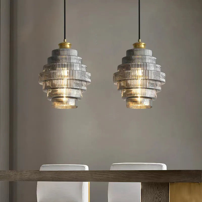 Modern simple pendant drop light in smoked grey or amber glass for hallway or bedroom.
