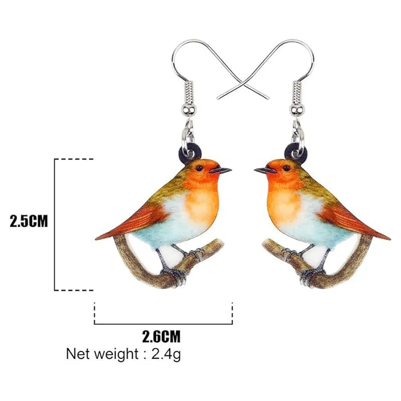 A pair of acrylic pendant earrings with a printed Blue Titmouse and snake design on geometric shapes.