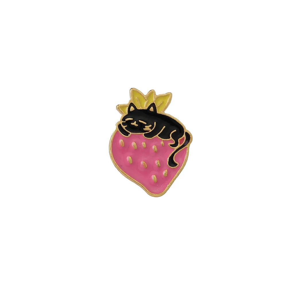 Close-up of a detailed alloy brooch showing a cute cat and strawberry in a dripping oil art style.