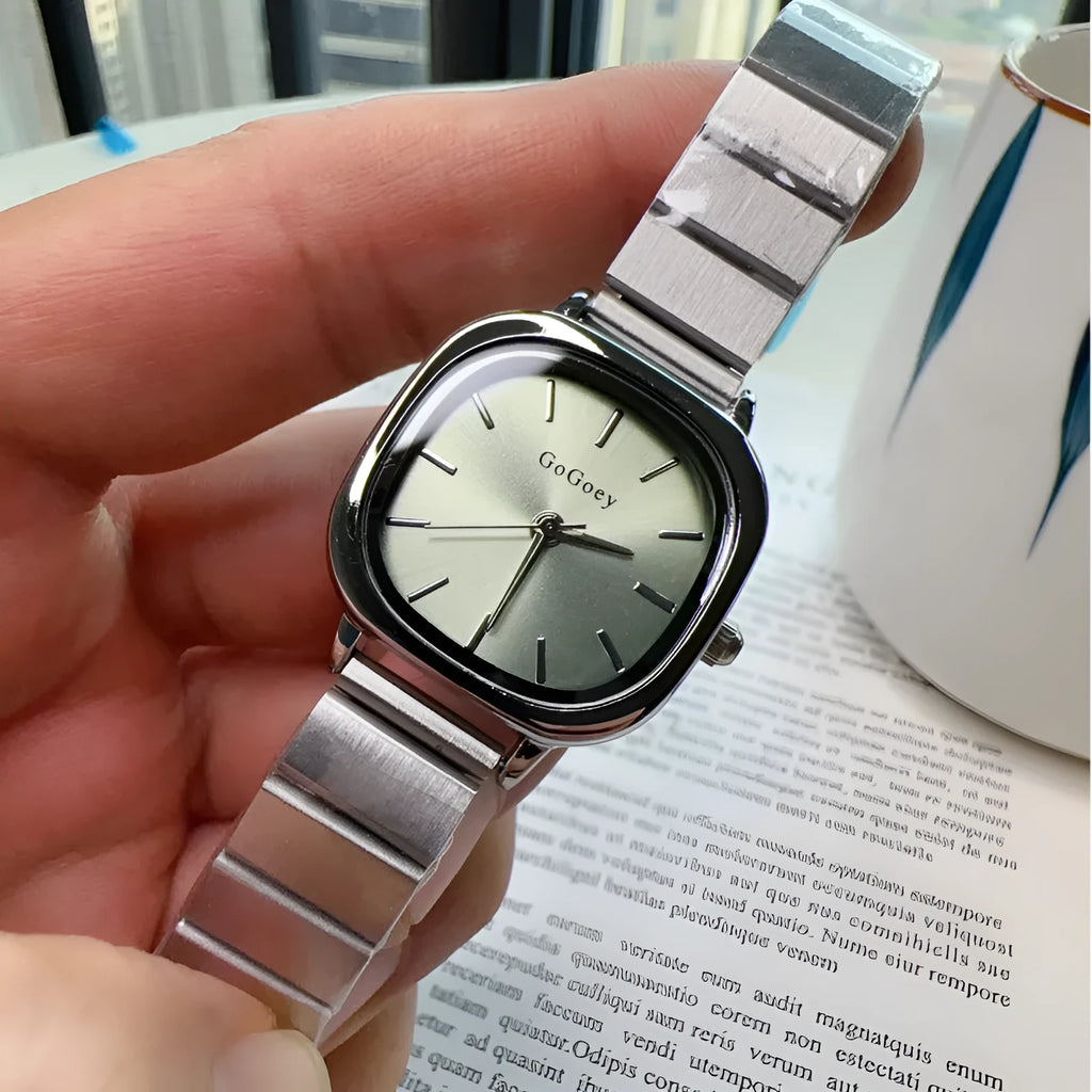 Women's quartz watch with metal case, steel strap and folding buckle, shown in gold or silver with green, white or gold surface