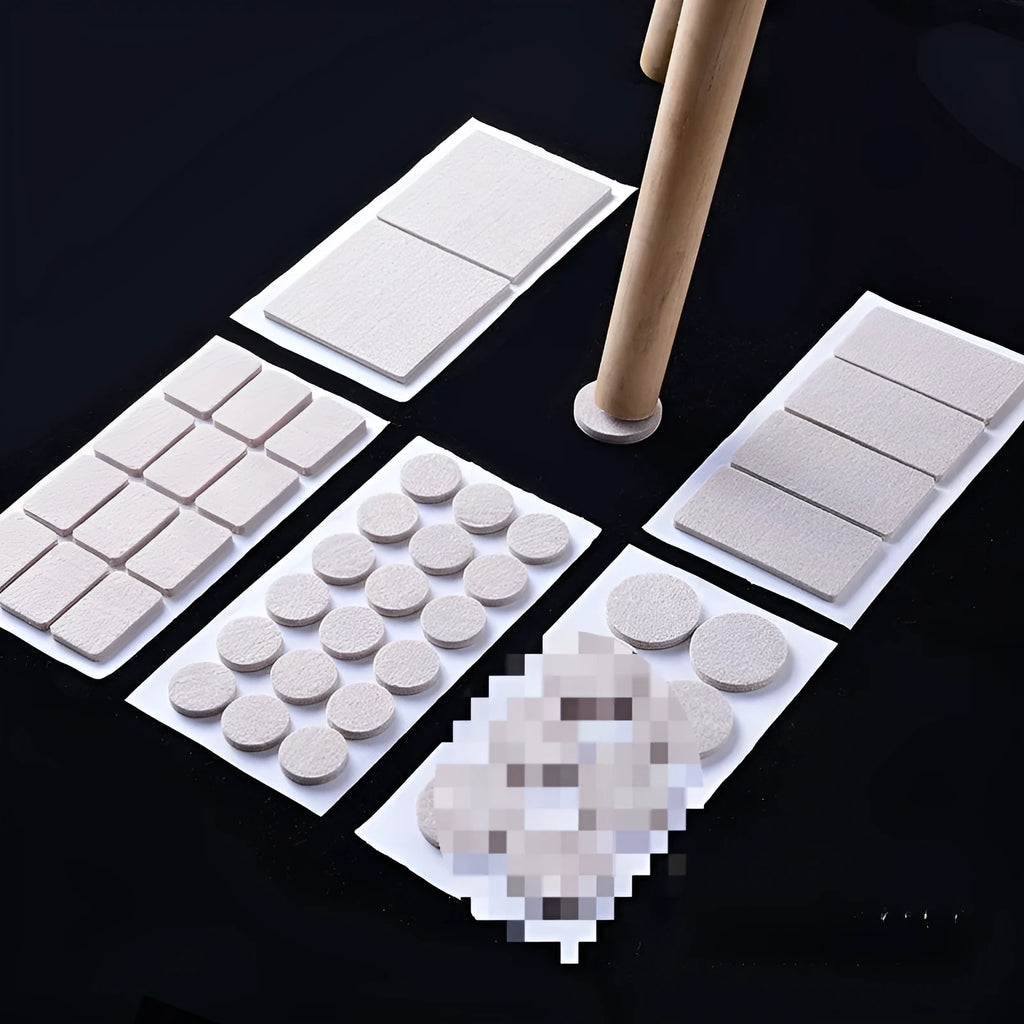 Beige plastic furniture protection foot pads in five different sizes on a wooden floor.