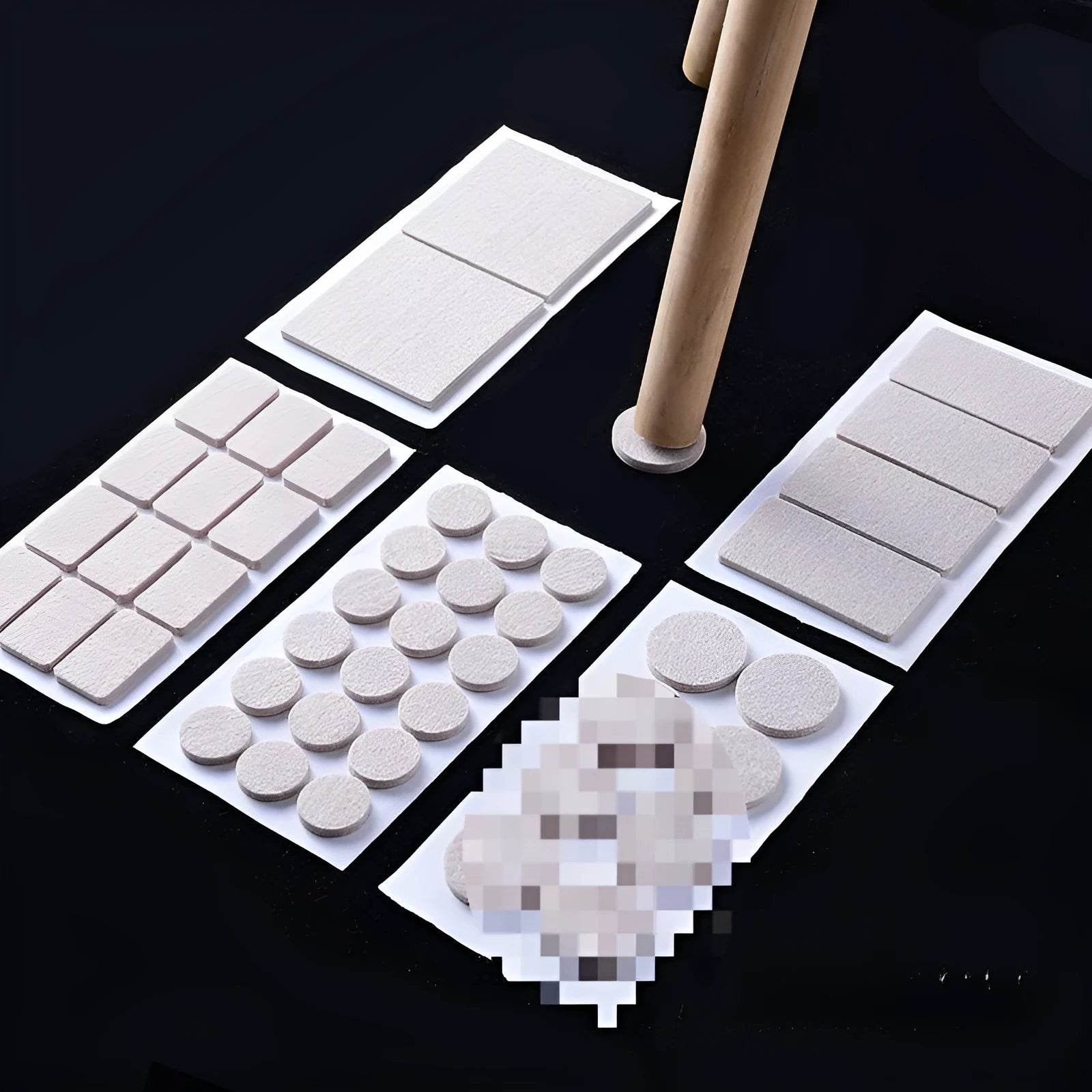 Beige plastic furniture protection foot pads in five different sizes on a wooden floor.