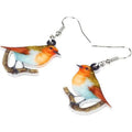 A pair of acrylic pendant earrings with a printed Blue Titmouse and snake design on geometric shapes.