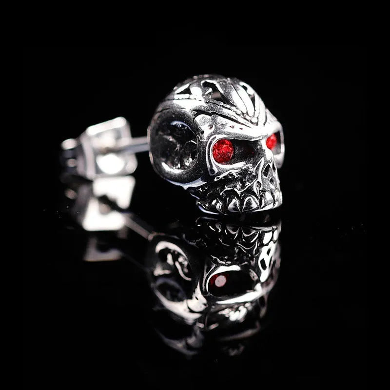 Pair of retro-style skull stud earrings with red gemstone eyes on alloy metal