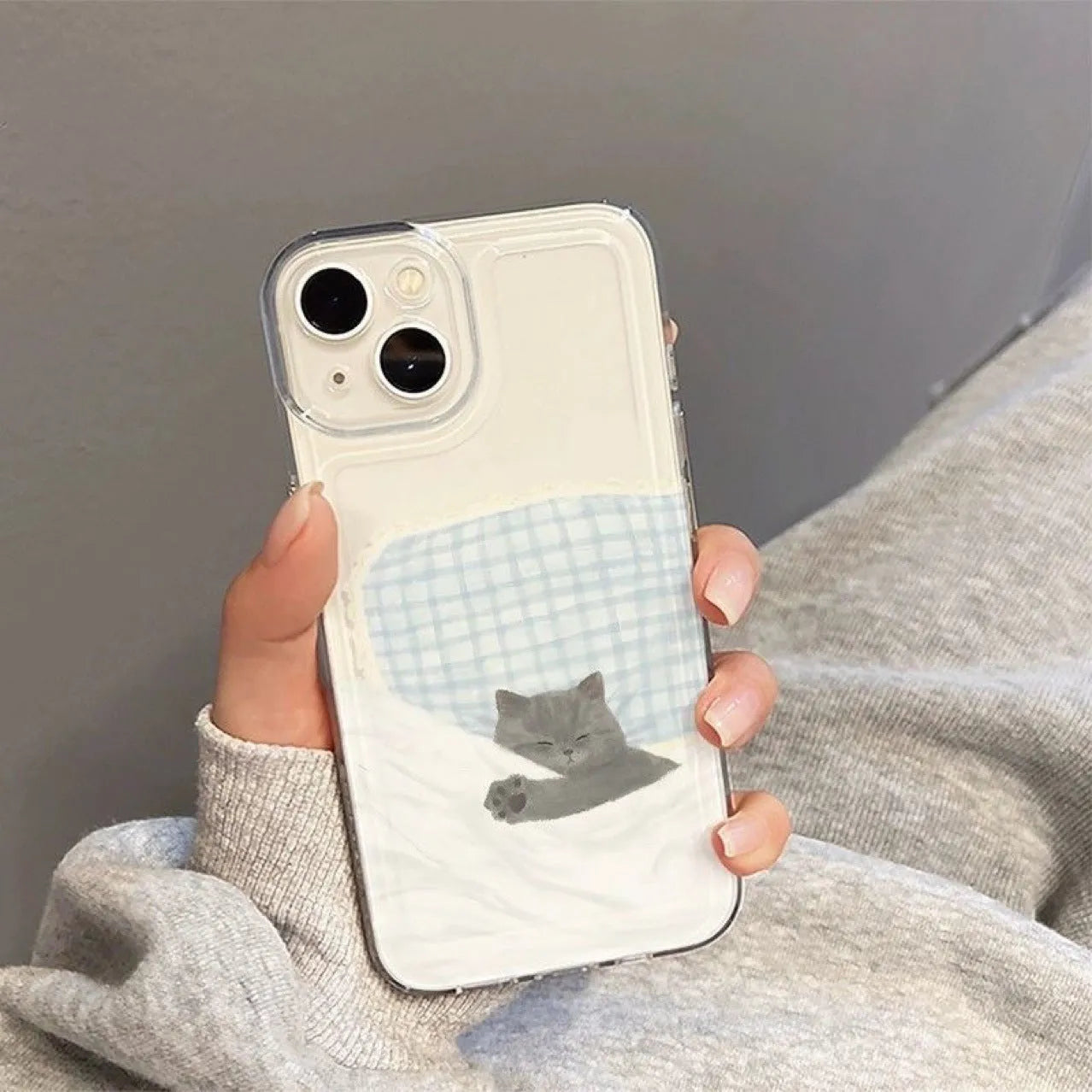Transparent Apple iPhone case showing sleeping cat space shell pattern on TPU material