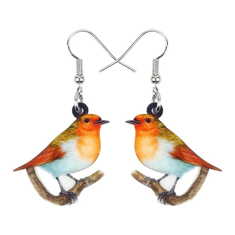 A pair of acrylic pendant earrings with a printed Blue Titmouse and snake design on geometric shapes.