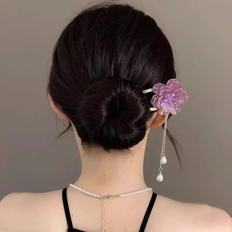 Close-up of a purple peony flower and tassel on a gold-toned U-shaped alloy hairpin.