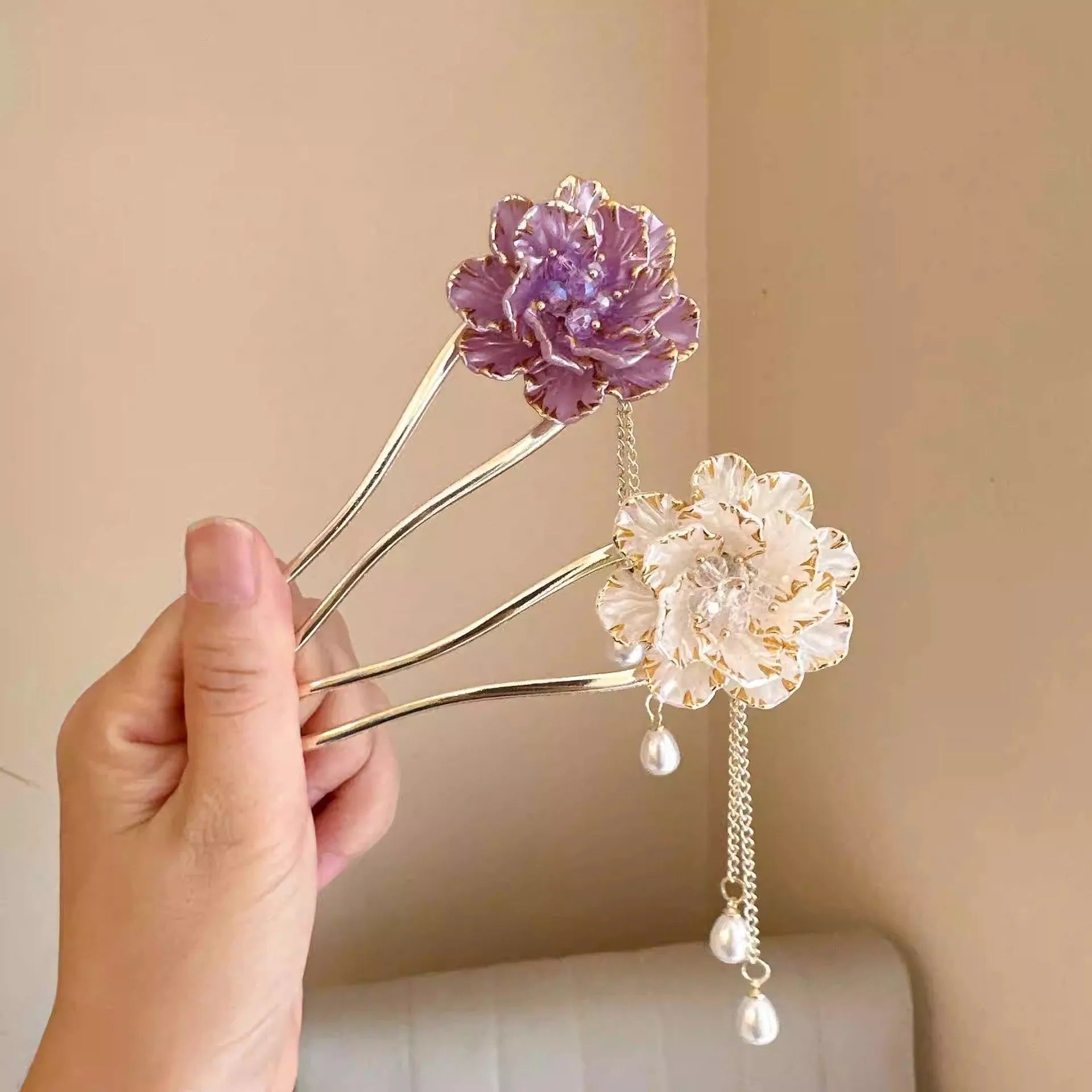 Close-up of a purple peony flower and tassel on a gold-toned U-shaped alloy hairpin.