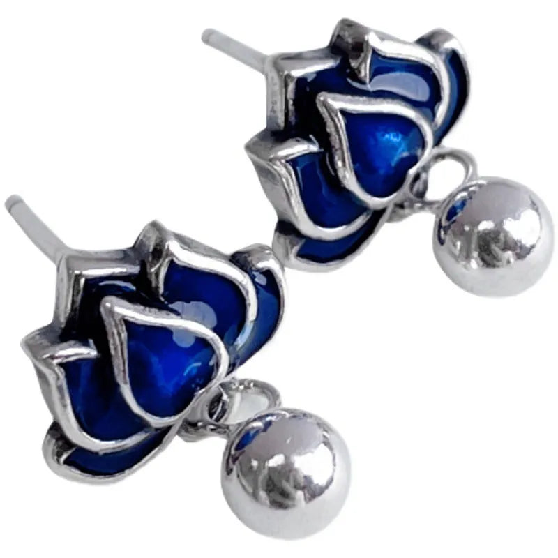 Blue alloy lotus seedpod and tassel dangle ear studs on a white background.