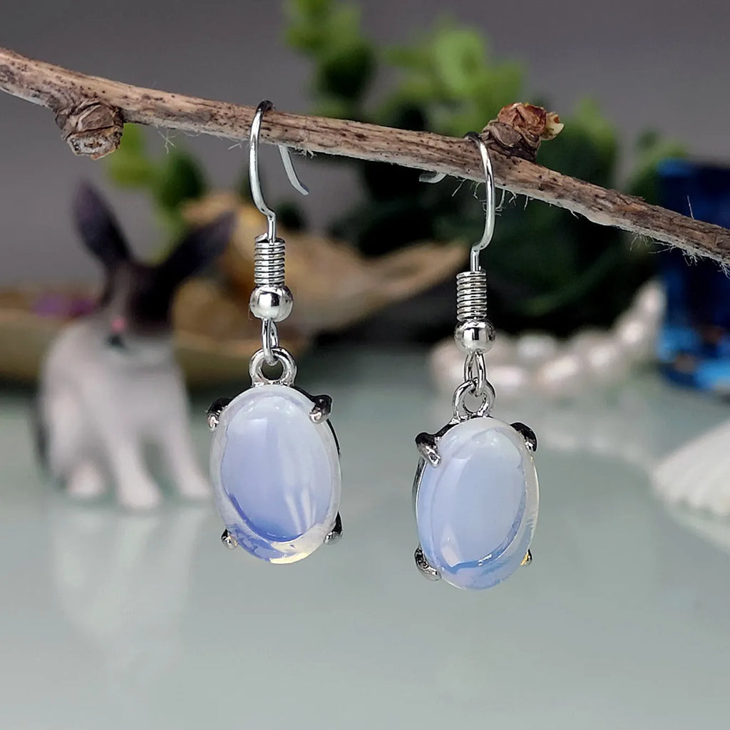 Moonlight white opal earrings with retro cross design and ellipse drop shape