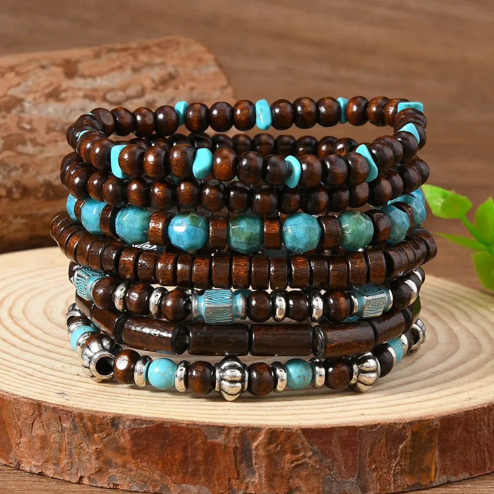 Seven multicolour wooden bead and alloy retro bracelets laid out showing round bead design