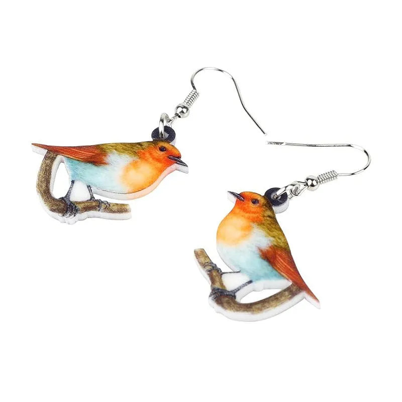 A pair of acrylic pendant earrings with a printed Blue Titmouse and snake design on geometric shapes.
