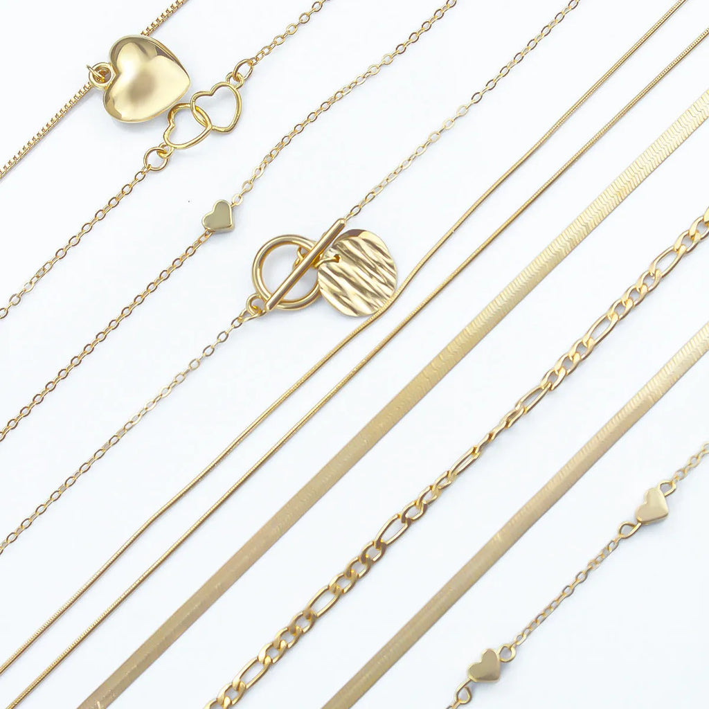 Gold electroplated women's necklace suit with ten pieces showing alloy pendants on snake bone chains