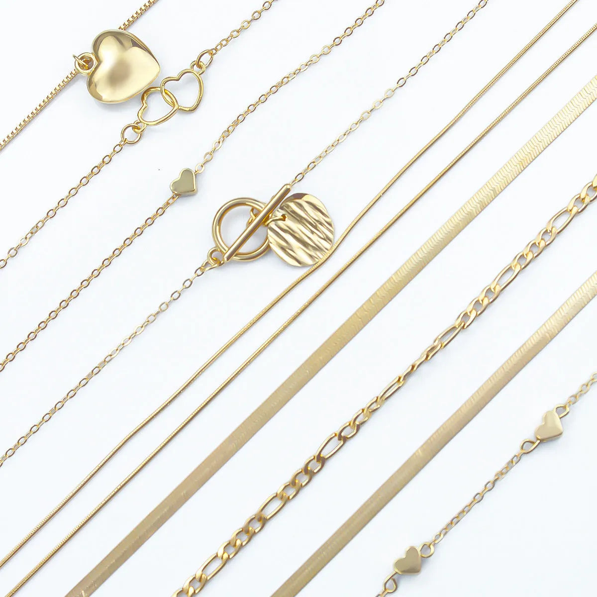 Gold electroplated women's necklace suit with ten pieces showing alloy pendants on snake bone chains