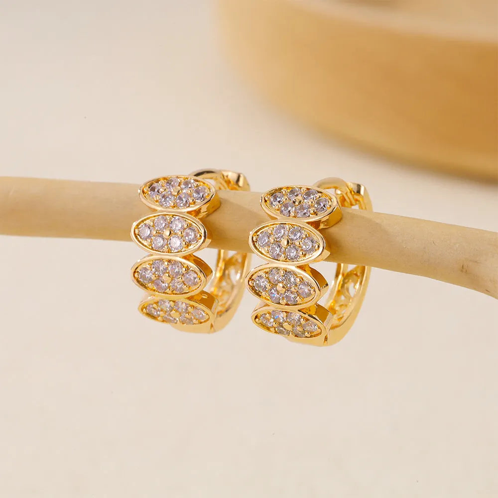 A pair of gold-coloured copper earrings with a zircon stone inlay in an ins style design.