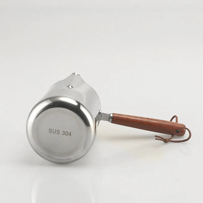 Stainless steel garland coffee cup with wooden handle and interior measurement scale.