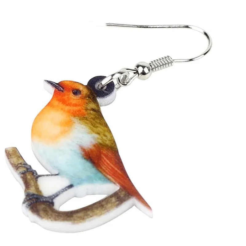 A pair of acrylic pendant earrings with a printed Blue Titmouse and snake design on geometric shapes.