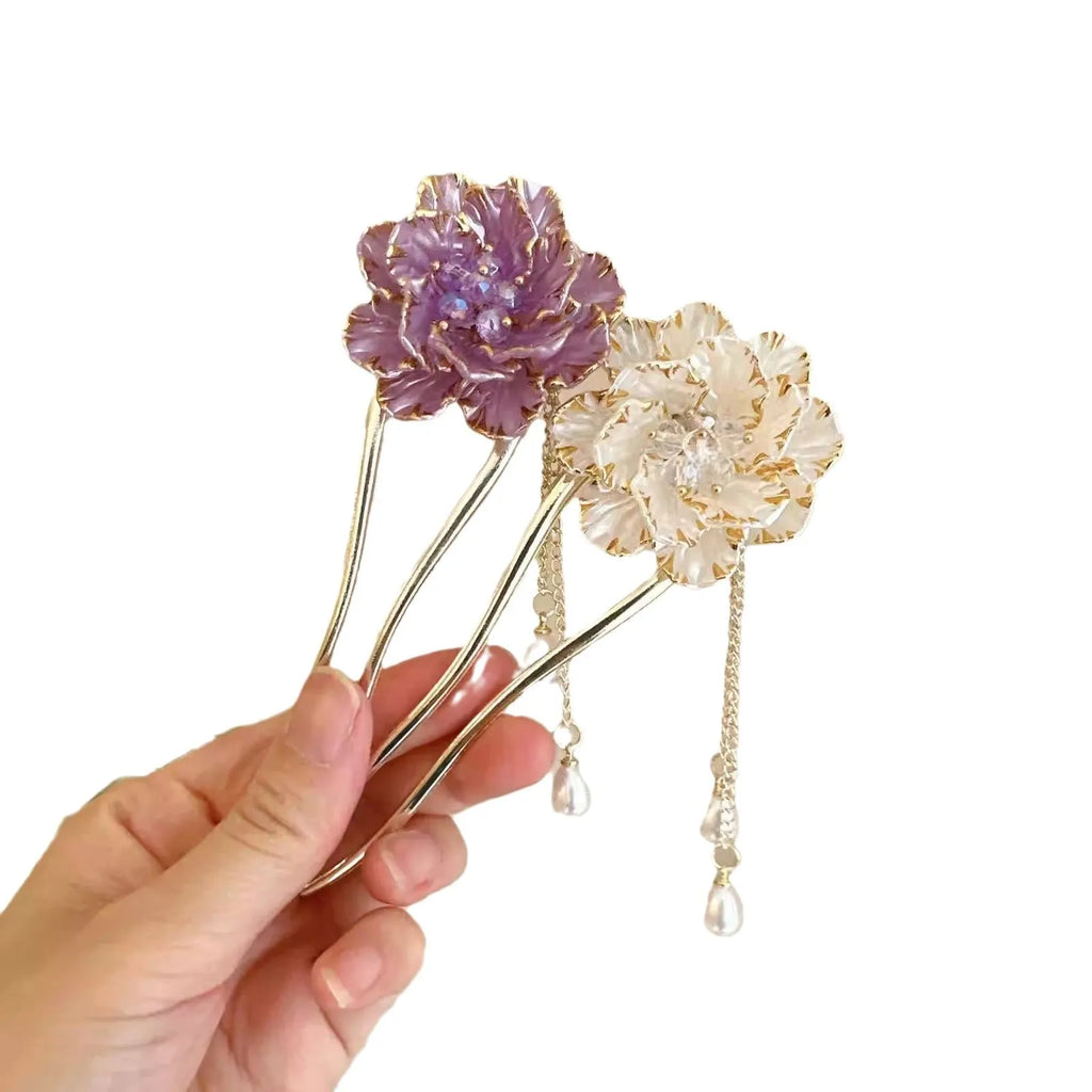 Close-up of a purple peony flower and tassel on a gold-toned U-shaped alloy hairpin.