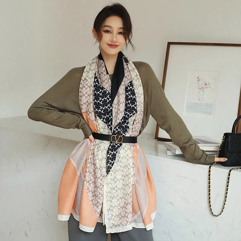 A woman wearing a printed polyester shawl, showcasing one of three available elegant styles, with dimensions of 180cm by 90cm.