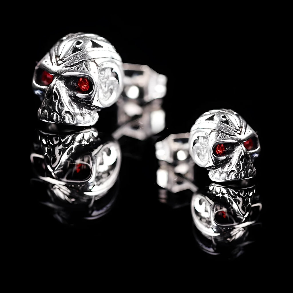 Pair of retro-style skull stud earrings with red gemstone eyes on alloy metal